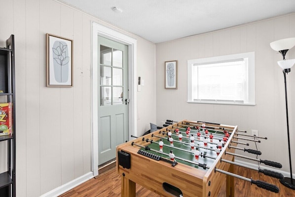 Enjoy a game of foosball on our gaming table and have fun in our simply decorated yet elegant gaming room.