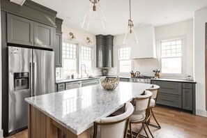 Kitchen: Whip up culinary delights in this elegant kitchen with stunning marble countertops!