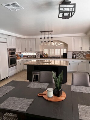 Spacious kitchen, looking out to backyard pool 
