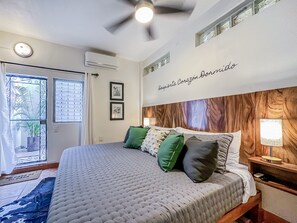 Primary bedroom with comfortable King size bed and entrance to private terrace