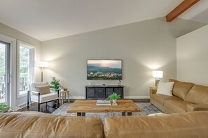 Cozy up in the living room with vaulted ceilings and 55" smart TV. 