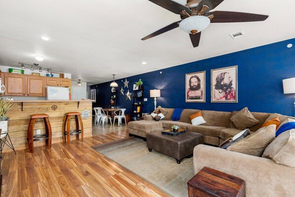 Unwind in the heart of Texas hill country charm, as you relax on a spacious sectional couch in this inviting open living room.