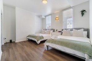 Very large bedroom with two Queen size bed and mattresses.