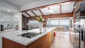 Open kitchen flooded with natural light through huge windows.
