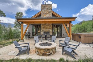 Private patio offering a dining area, firepit, grill and hot tub.