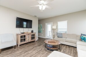 Cozy living space with queen size sleeper sofa, flat screen TV and access to private balcony on the third floor