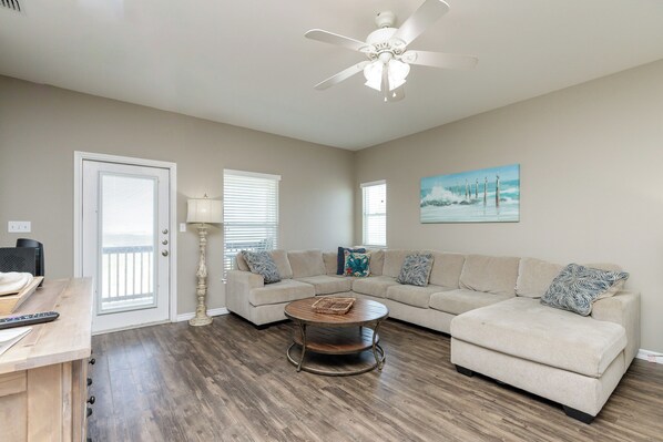 Cozy living space with queen size sleeper sofa and access to private balcony on the third floor
