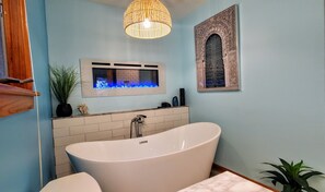 Master bath with soaking tub and spa like chandelier.