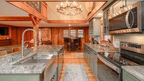  Sleek, Stunning Kitchen. Top-Quality Cabinetry with Solid Surface Countertops.