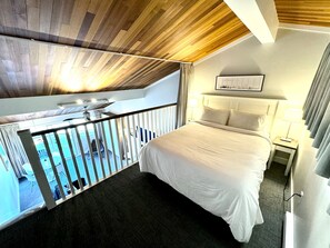 A comfy queen-sized bed in the loft. 1 of 3 beds in the Suite. 