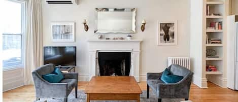 Open concept living room with large windows.

