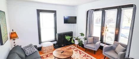 First floor living room with sun and park views