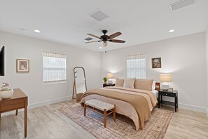 Unwind in the master suite’s vibrant, airy atmosphere—an inviting space to relax and recharge.