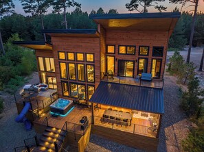 Cabin with the hot tub nestled up against the cabin. Plenty of deck space to spread out.