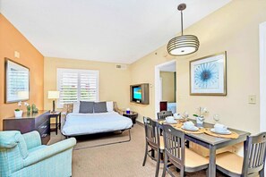 Open-layout dining and living area with sofa bed 