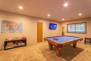 An 8-ft pool table, smart TV, board games, and even axe throwing are waiting for you