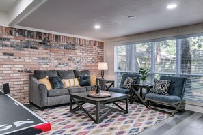 sunroom with ping pong table and pull out couch