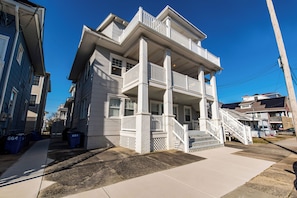 Beach chairs and umbrella are stored under the porch, cubby to left.