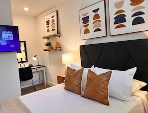 Bedroom has its own TV and dressing/desk area.