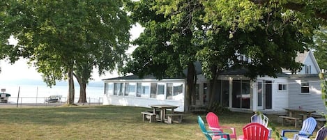 OVERVIEW:  The cottage, bonfire ring, and yard with Crystal Lake in the background.