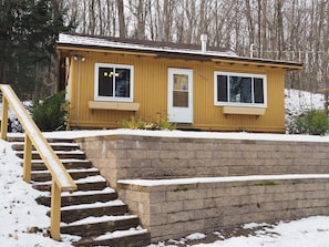 OVERALL: The outside of the cabin in the winter.