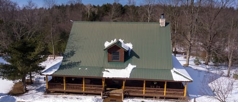 OVERALL:  Aerial photo of the front of the cabin in the winter.