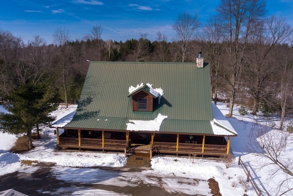 OVERALL:  Aerial photo of the front of the cabin in the winter.