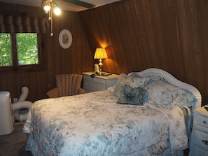 BEDROOM:  Includes a queen-size bed, dressers, night lamps, ceiling fan, closet, and room A/C unit.