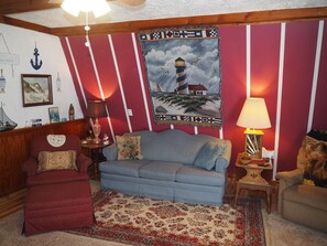 LIVING ROOM:  Includes a sofa, comfy chairs, live-streaming television, and entrance out to the deck.