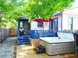 OVERALL:  The fully fenced-in backyard with newly expanded deck, new hot tub, propane grill, and picnic table with umbrella.