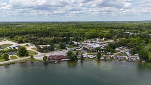 OVERALL:  A drone shot of the lake with the house in the background and The Turk Lake Restaurant and Bar just to the left of it