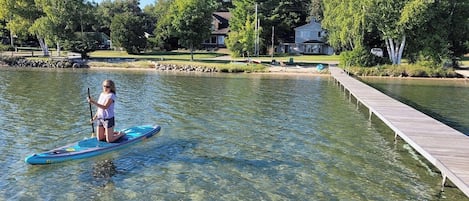 OVERVIEW:  The huge dock and gorgeous lakefront right in front of the house.  Note that the water is very clear, sandy, and shallow, which makes it great for all kinds of family fun!