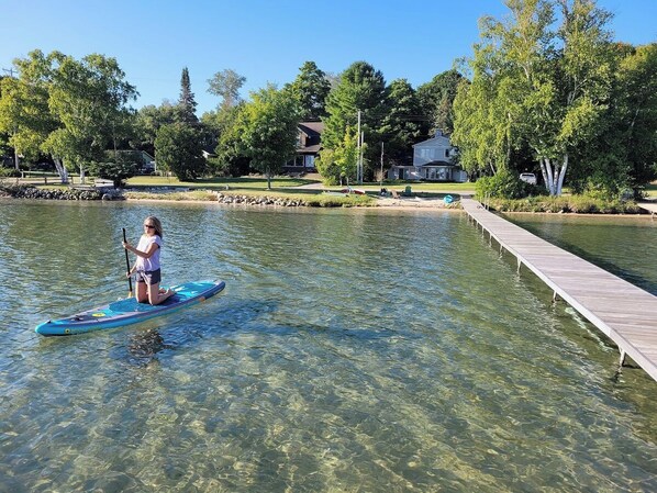 OVERVIEW:  The huge dock and gorgeous lakefront right in front of the house.  Note that the water is very clear, sandy, and shallow, which makes it great for all kinds of family fun!