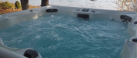 OVERVIEW:  The new year-round hot tub with Bass Lake and the private lakefront in the background