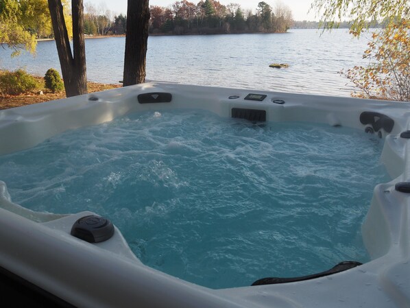 OVERVIEW:  The new year-round hot tub with Bass Lake and the private lakefront in the background