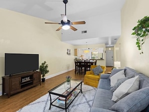 Living room next to the dining room. Smart TV with board games