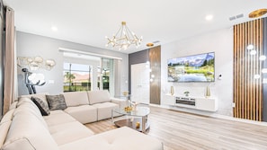 Elegant living room, grandly appointed with a focal TV for luxurious entertainment and relaxation