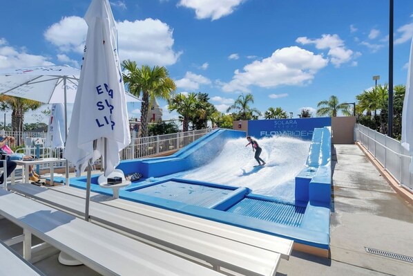The resort FlowRider is an exhilarating attraction that brings the thrill of surfing to a controlled, fun environment. It features a large, continuous wave machine that generates a smooth, flowing wave for surfing or bodyboarding.