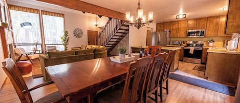 Large dining room table seats 8 plus 3 stools at the counter.