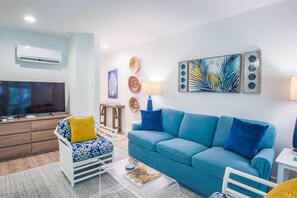 The hallways from the front door connects to the living room.