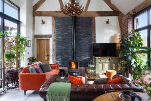 Elegant sitting room with exposed beams and stonework