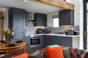 Well-equipped kitchen with an electric oven and hob and Krupps Nespresso coffee machine