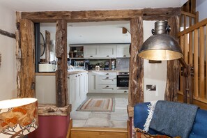 Exposed beams highlight the kitchen area from the living area