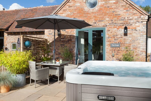 The spacious terrace boasts a hot-tub, perfect for whiling away the evening