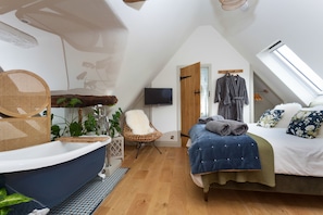 Relax in the stunning roll-top bath and retire to the sumptuous bed
