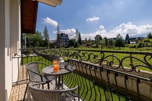 A private balcony offering charming views of the surrounding landscape, ideal for morning coffee or evening relaxation.