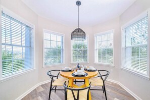 Dining area surrounded by large windows