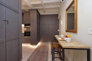 Gorgeous modern kitchen has a cute dining spot.