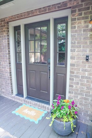 FRONT DOOR WITH KEYLESS ENTRY AND HAPPY PLANTS 
7 DOOR MAT