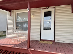 Front porch with table and seating for two